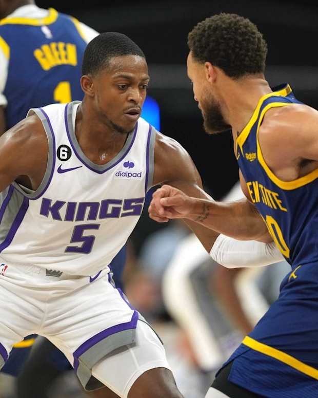 Oct 23, 2022; San Francisco, California, USA; Sacramento Kings guard De'Aaron Fox (5) guards Golden State Warriors guard Stephen Curry (30) during the first quarter at Chase Center. Mandatory Credit: Darren Yamashita-USA TODAY Sports